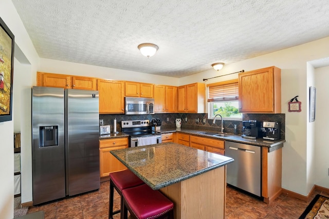 8380 Squad Dr, Galloway, OH 43119 - kitchen with stainless steel appliances, a sink, backsplash, and a breakfast bar area