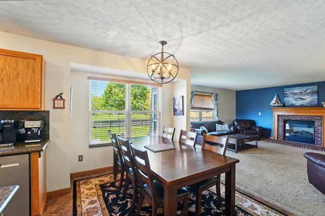 8380 Squad Dr, Galloway, OH 43119 - dining room with a chandelier, a fireplace, a textured ceiling, and baseboards