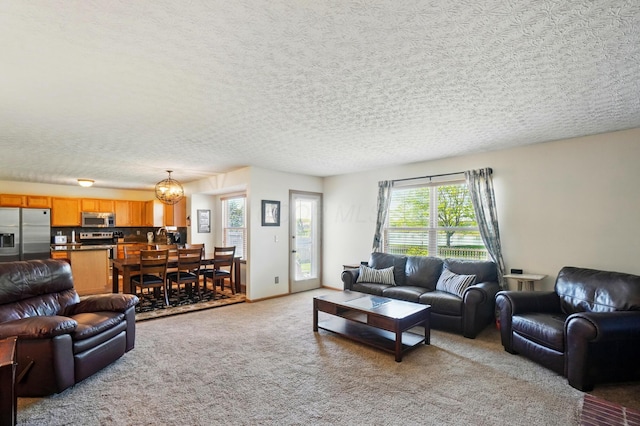 8380 Squad Dr, Galloway, OH 43119 - living room with light carpet, a chandelier, and a textured ceiling