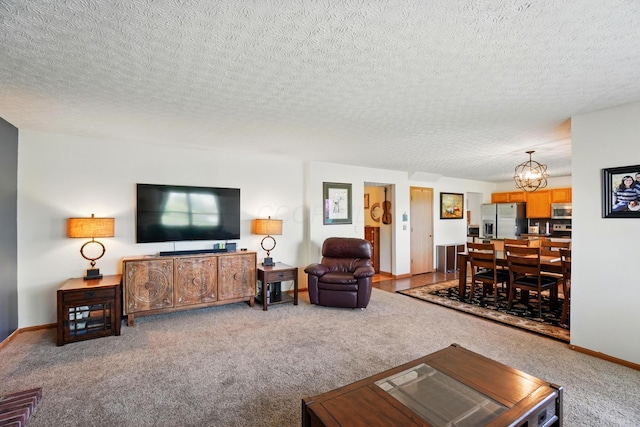 8380 Squad Dr, Galloway, OH 43119 - carpeted living room with a chandelier, a textured ceiling, and baseboards