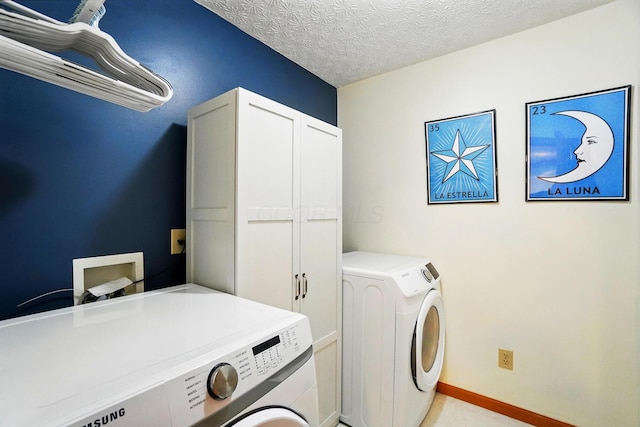 8380 Squad Dr, Galloway, OH 43119 - laundry area featuring independent washer and dryer, cabinet space, a textured ceiling, and baseboards