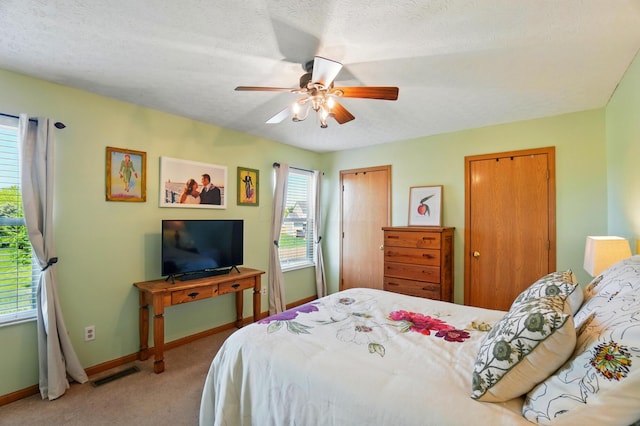 8380 Squad Dr, Galloway, OH 43119 - carpeted bedroom featuring baseboards, multiple closets, ceiling fan, and a textured ceiling