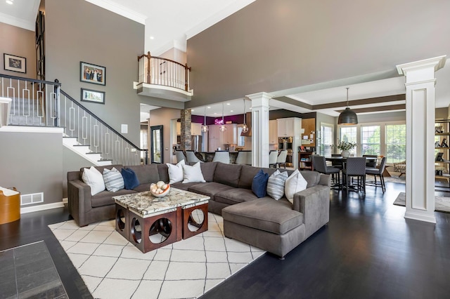 4166 Borge Way, Dublin, OH 43016 - living area with decorative columns, crown molding, wood finished floors, stairs, and baseboards