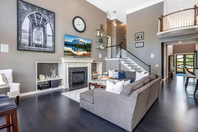 4166 Borge Way, Dublin, OH 43016 - living area featuring a towering ceiling, stairs, wood finished floors, baseboards, and a tiled fireplace
