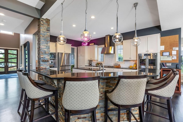 4166 Borge Way, Dublin, OH 43016 - kitchen featuring stainless steel appliances, dark countertops, wall chimney exhaust hood, backsplash, and recessed lighting