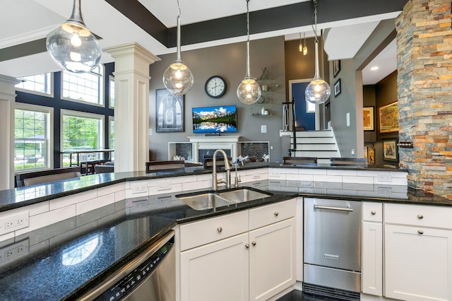 4166 Borge Way, Dublin, OH 43016 - kitchen with a sink, decorative columns, dark stone countertops, hanging light fixtures, and white cabinets
