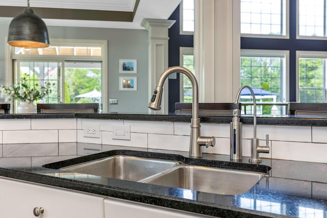 4166 Borge Way, Dublin, OH 43016 - kitchen view of a sink, ornate columns, white cabinetry, and dark stone countertops