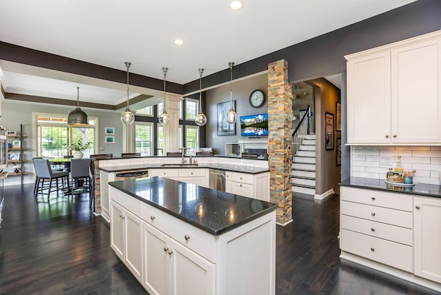 4166 Borge Way, Dublin, OH 43016 - kitchen featuring a center island, a sink, dark wood-style floors, tasteful backsplash, and hanging light fixtures