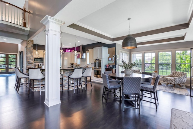 4166 Borge Way, Dublin, OH 43016 - dining space with decorative columns, a tray ceiling, dark wood-style floors, and ornamental molding