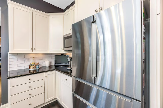 4166 Borge Way, Dublin, OH 43016 - kitchen with stainless steel appliances, dark countertops, and white cabinetry