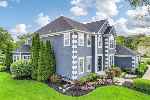 4166 Borge Way, Dublin, OH 43016 - view of side of property with stucco siding, a yard, and roof with shingles