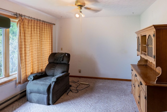 living area with a baseboard radiator, light carpet, ceiling fan, and baseboards