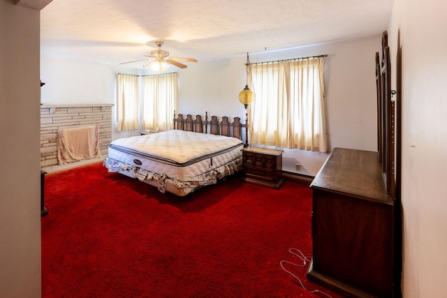 bedroom with dark colored carpet and a ceiling fan