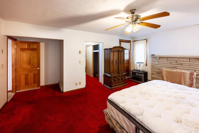bedroom featuring baseboards, dark carpet, and ceiling fan
