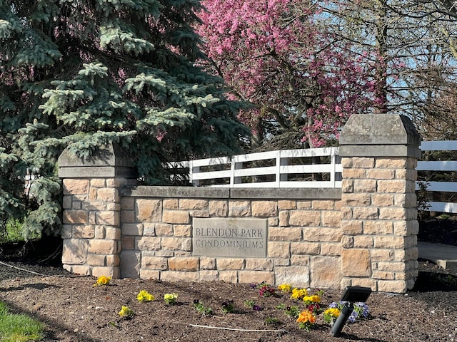 community sign featuring fence