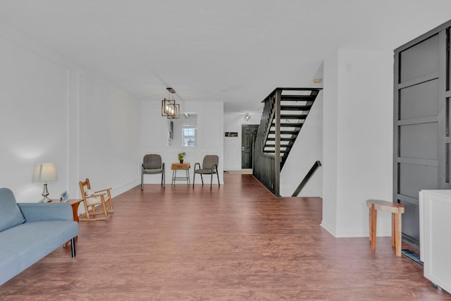 sitting room featuring wood finished floors and stairs