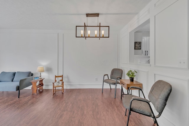 living area featuring a chandelier and wood finished floors