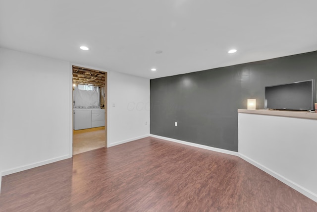 finished basement with washer and clothes dryer, recessed lighting, wood finished floors, and baseboards
