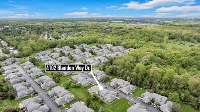 aerial view of residential area with a heavily wooded area