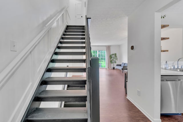 stairway featuring wood finished floors