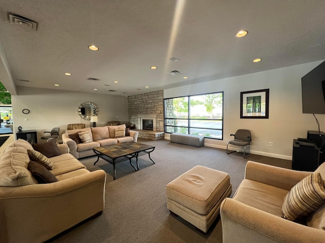 4102 Blendon Way Dr, Columbus, OH 43230 - living room featuring carpet floors, recessed lighting, a stone fireplace, and a textured ceiling