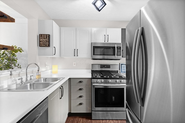 4102 Blendon Way Dr, Columbus, OH 43230 - kitchen featuring appliances with stainless steel finishes, light countertops, dark wood finished floors, and white cabinets