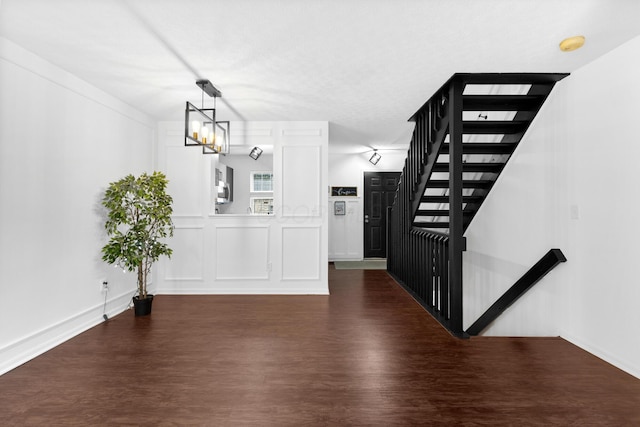 4102 Blendon Way Dr, Columbus, OH 43230 - unfurnished dining area with dark wood finished floors, a chandelier, and stairs
