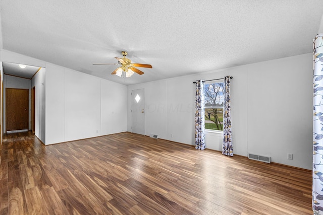 8164 Atlantic St, Caledonia, OH 43314 - unfurnished living room featuring ceiling fan, wood finished floors, and a textured ceiling