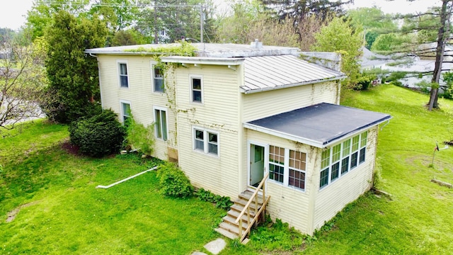 back of house with a lawn