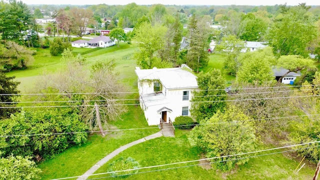 view of subject property featuring a tree filled landscape