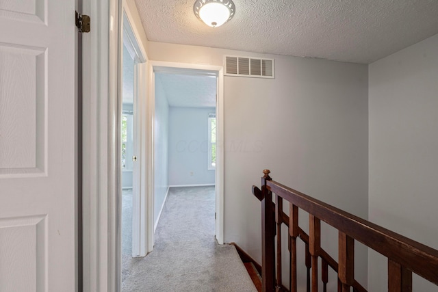 3860 Julia Ct, Columbus, OH 43230 - hall featuring an upstairs landing, carpet, a textured ceiling, and baseboards