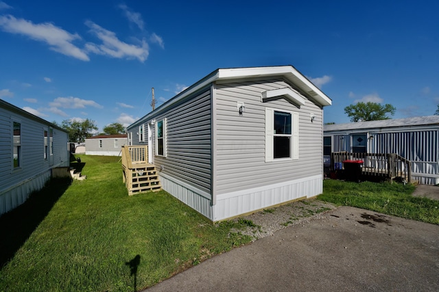 view of side of home with a yard
