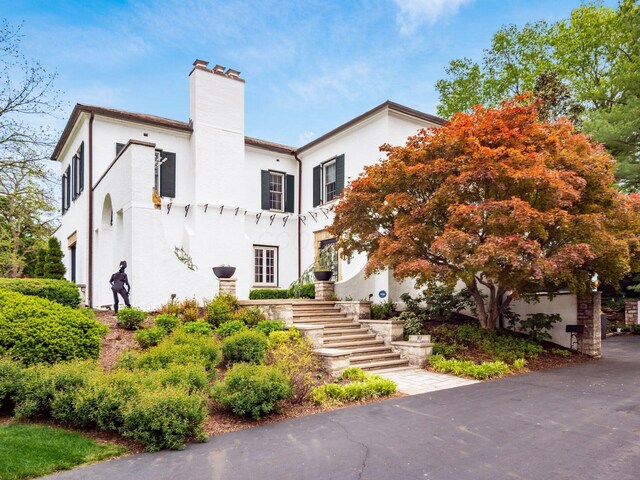 10 Park Dr, Columbus, OH 43209 - mediterranean / spanish-style house with stairs, a chimney, and stucco siding