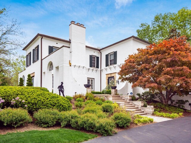 10 Park Dr, Columbus, OH 43209 - view of front facade featuring a chimney, stairway, and stucco siding
