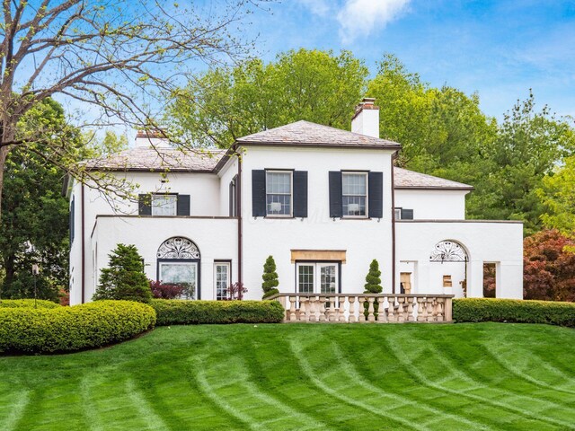 10 Park Dr, Columbus, OH 43209 - rear view of house with a chimney, a yard, stucco siding, and a high end roof