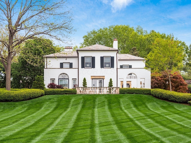 10 Park Dr, Columbus, OH 43209 - view of front facade featuring a chimney, stucco siding, and a front lawn