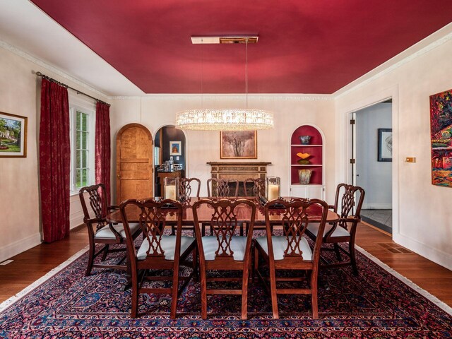 10 Park Dr, Columbus, OH 43209 - dining area featuring wood finished floors, baseboards, a chandelier, and ornamental molding