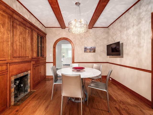 10 Park Dr, Columbus, OH 43209 - dining area featuring dark wood-style flooring, beamed ceiling, arched walkways, a chandelier, and baseboards