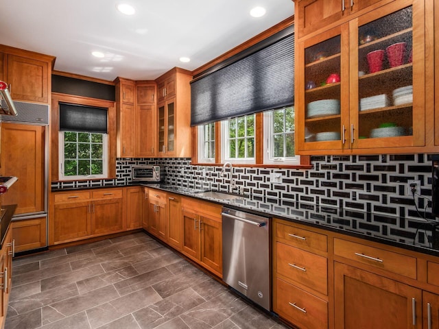 10 Park Dr, Columbus, OH 43209 - kitchen with stainless steel dishwasher, a sink, brown cabinets, plenty of natural light, and recessed lighting