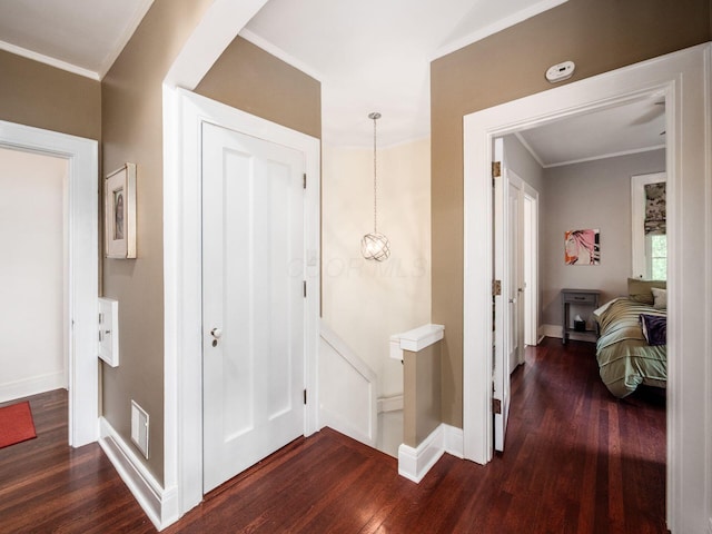 10 Park Dr, Columbus, OH 43209 - hall with dark wood-style flooring, baseboards, crown molding, and an upstairs landing
