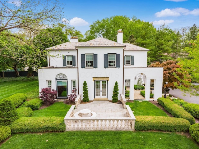 10 Park Dr, Columbus, OH 43209 - back of property featuring french doors, a chimney, stucco siding, and a lawn