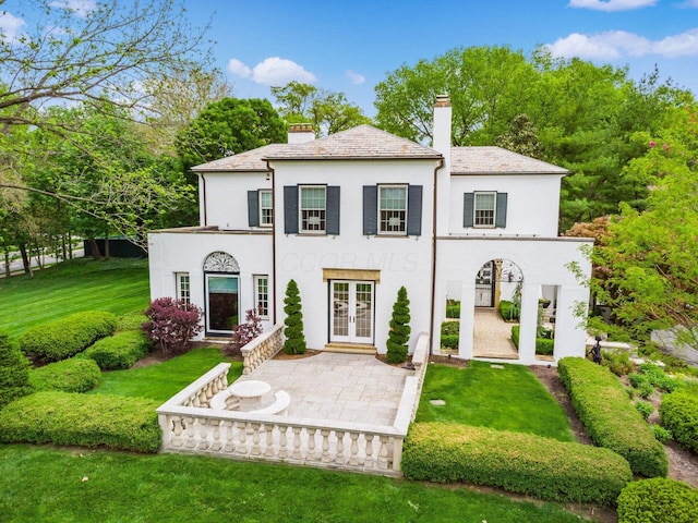 10 Park Dr, Columbus, OH 43209 - rear view of property featuring french doors, a chimney, stucco siding, and a lawn