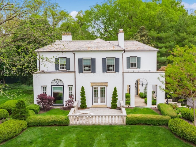 10 Park Dr, Columbus, OH 43209 - back of property featuring french doors, stucco siding, a chimney, and a lawn