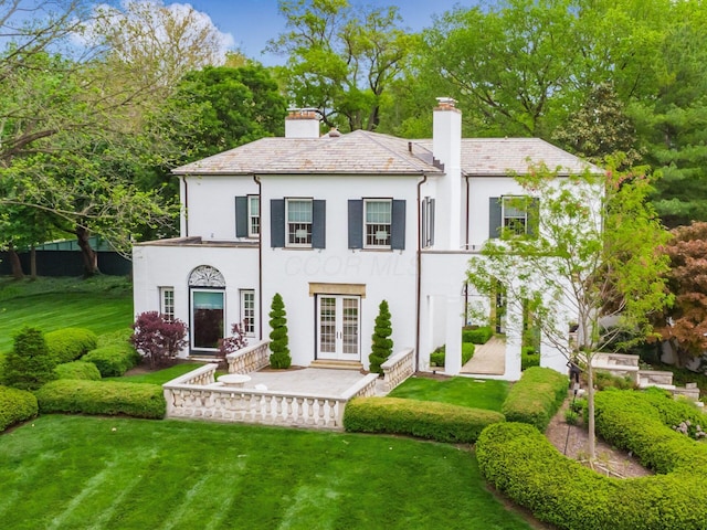 10 Park Dr, Columbus, OH 43209 - view of front of property with french doors, stucco siding, a chimney, a high end roof, and a front lawn