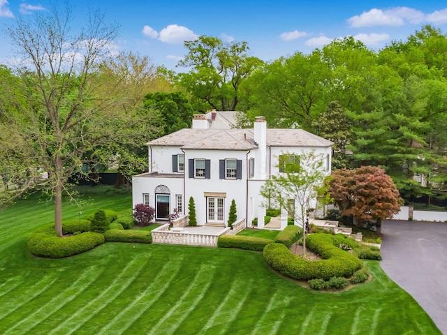 10 Park Dr, Columbus, OH 43209 - back of house featuring french doors, stucco siding, a chimney, and a lawn