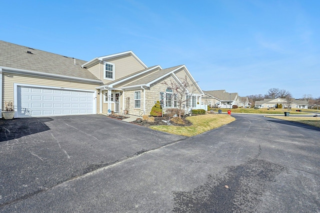 1753 Chestnut Farms Loop, Grove City, OH 43123 - view of front facade with driveway, an attached garage, stone siding, and a residential view