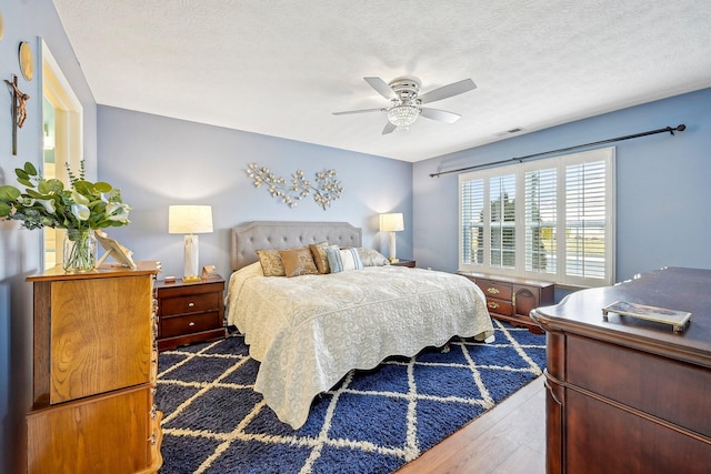 1753 Chestnut Farms Loop, Grove City, OH 43123 - bedroom with wood finished floors, ceiling fan, and a textured ceiling