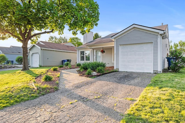 2458 Dunsworth Dr, Columbus, OH 43235 - view of front facade with a front lawn, a chimney, asphalt driveway, and a garage