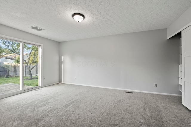 2458 Dunsworth Dr, Columbus, OH 43235 - carpeted empty room featuring a textured ceiling and baseboards