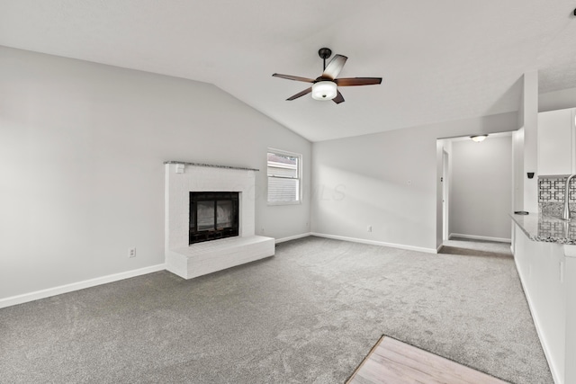 2458 Dunsworth Dr, Columbus, OH 43235 - unfurnished living room with ceiling fan, carpet floors, a fireplace, baseboards, and lofted ceiling